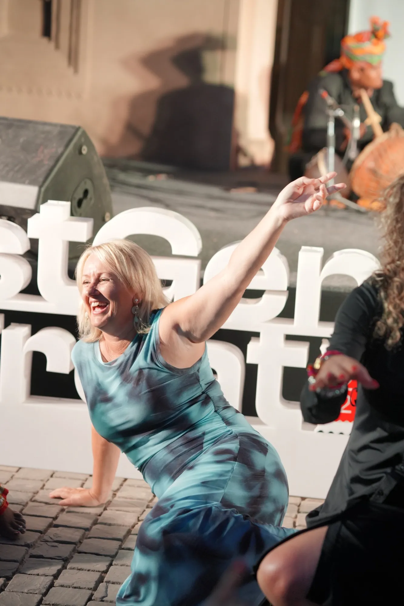 A guest dancing in front of the NestGen Retreat sign