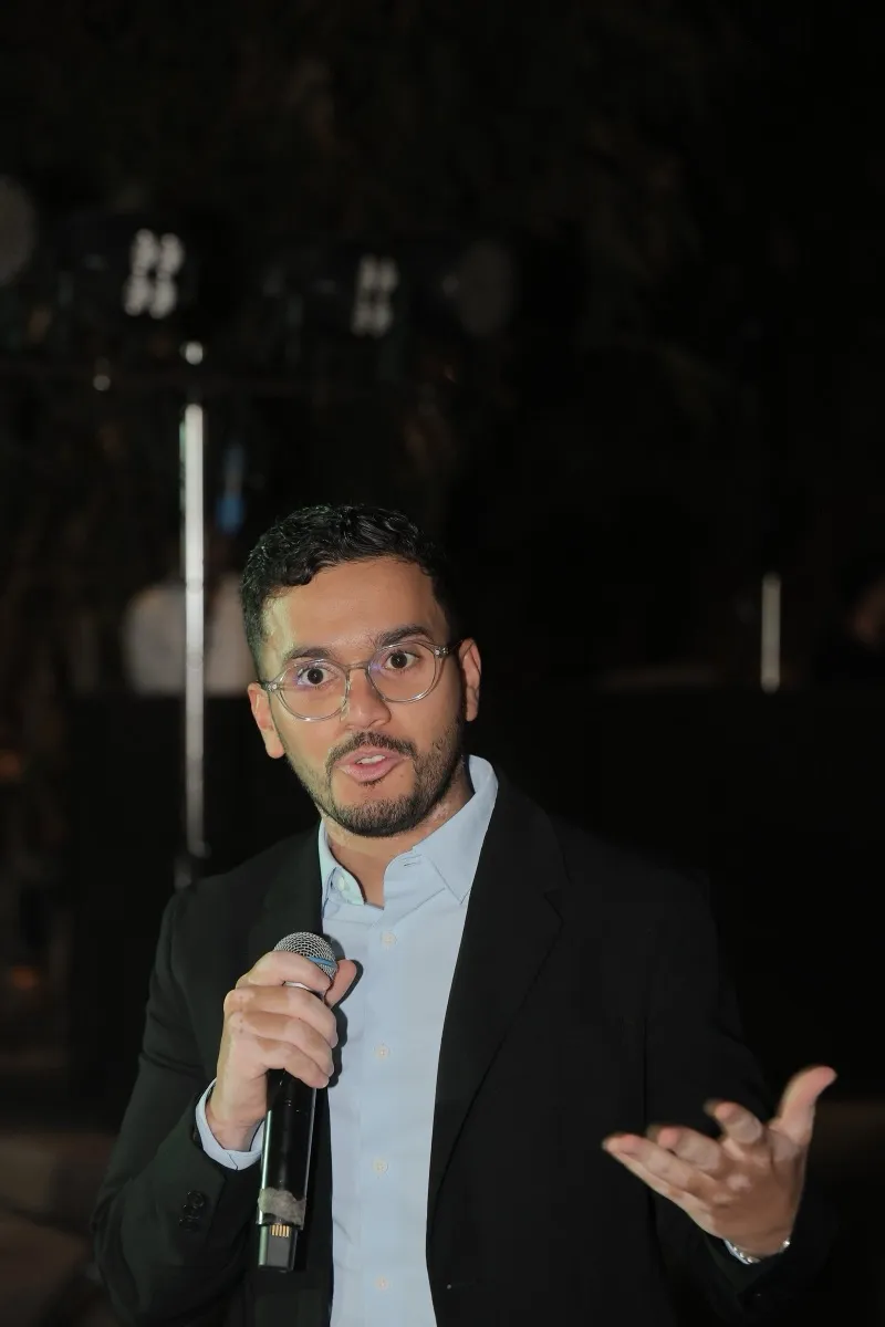 A guest speaking into a microphone at the Aagman evening