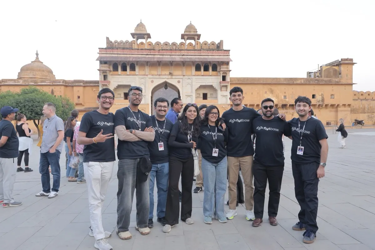 The FlytBase team in matching black tees in front of the gate at Amer Fort