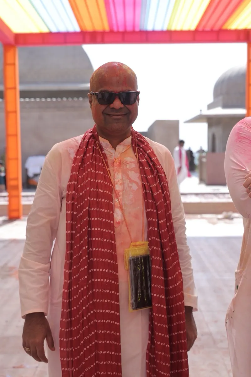 A guest in a red bandhani dupatta on the rooftop