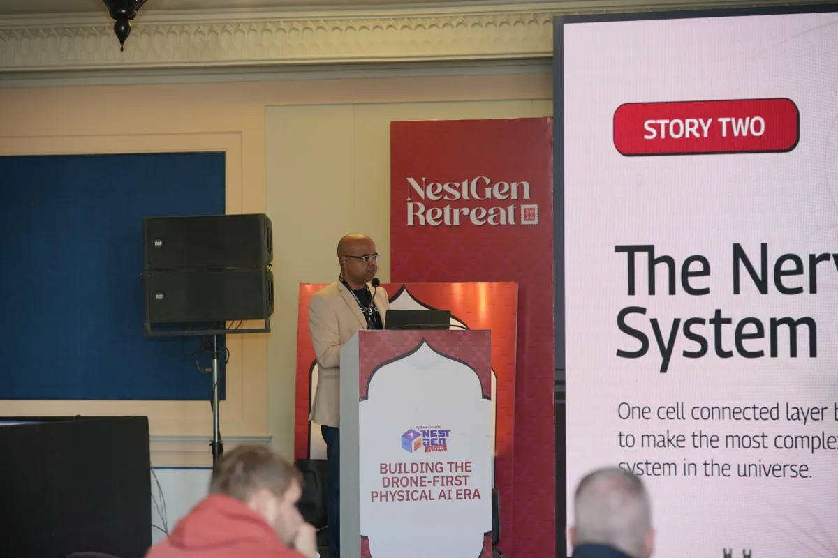 A speaker at the lectern beside a slide reading Story Two, The Nervous System
