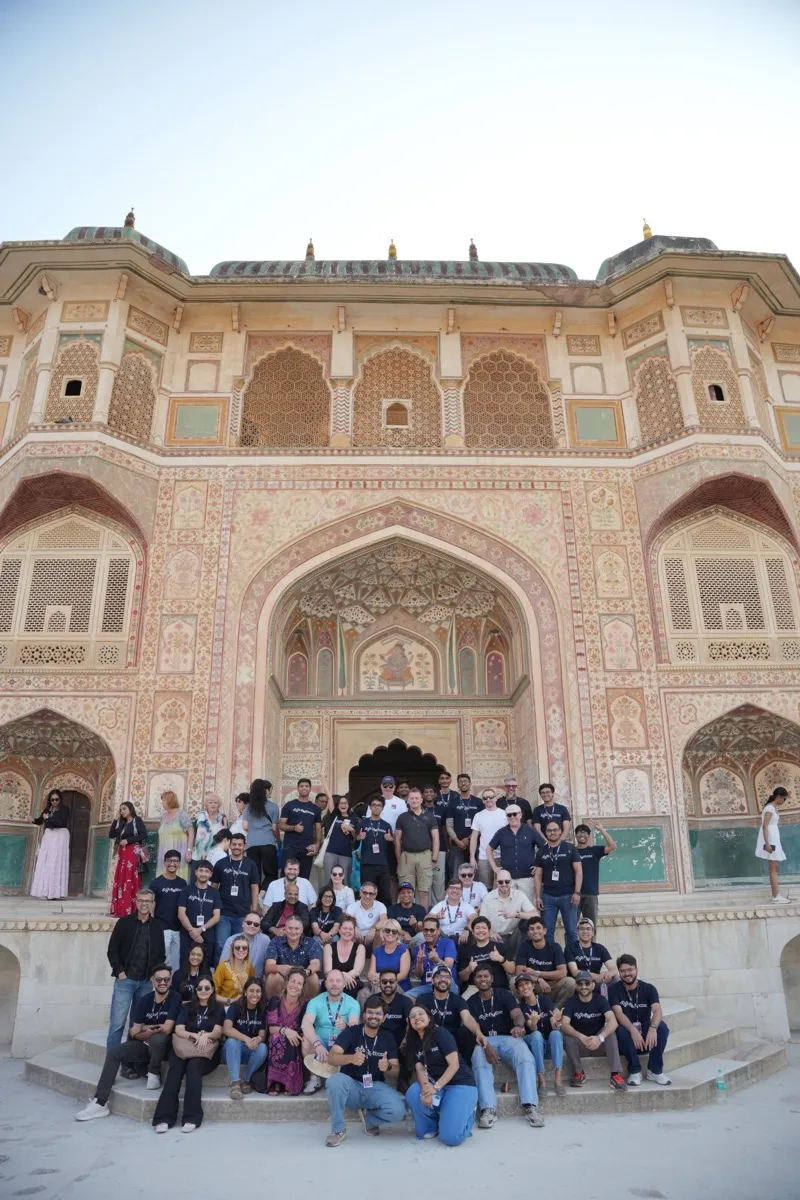 The whole retreat posed on the steps of the painted gate at Amer Fort