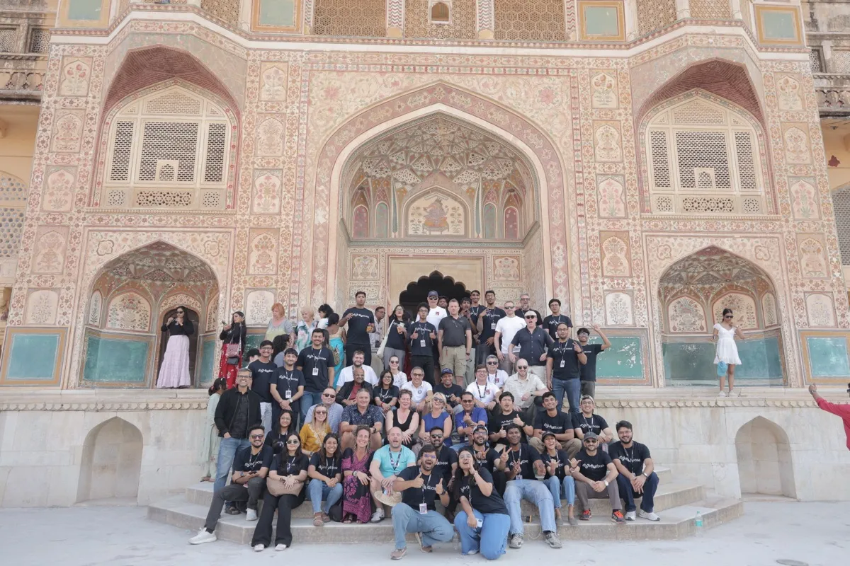 The group seated in front of the painted Ganesh Pol gate