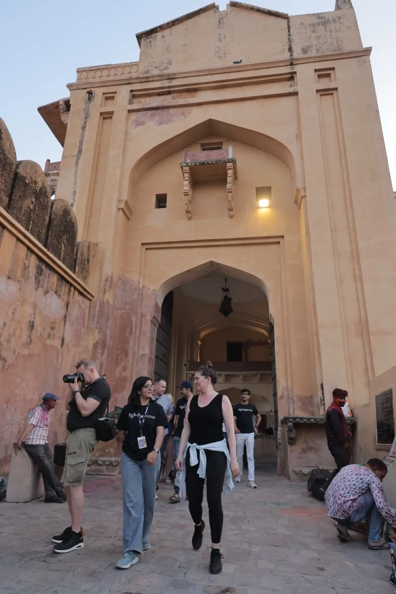Guests walking through an arched gate of the fort at dusk