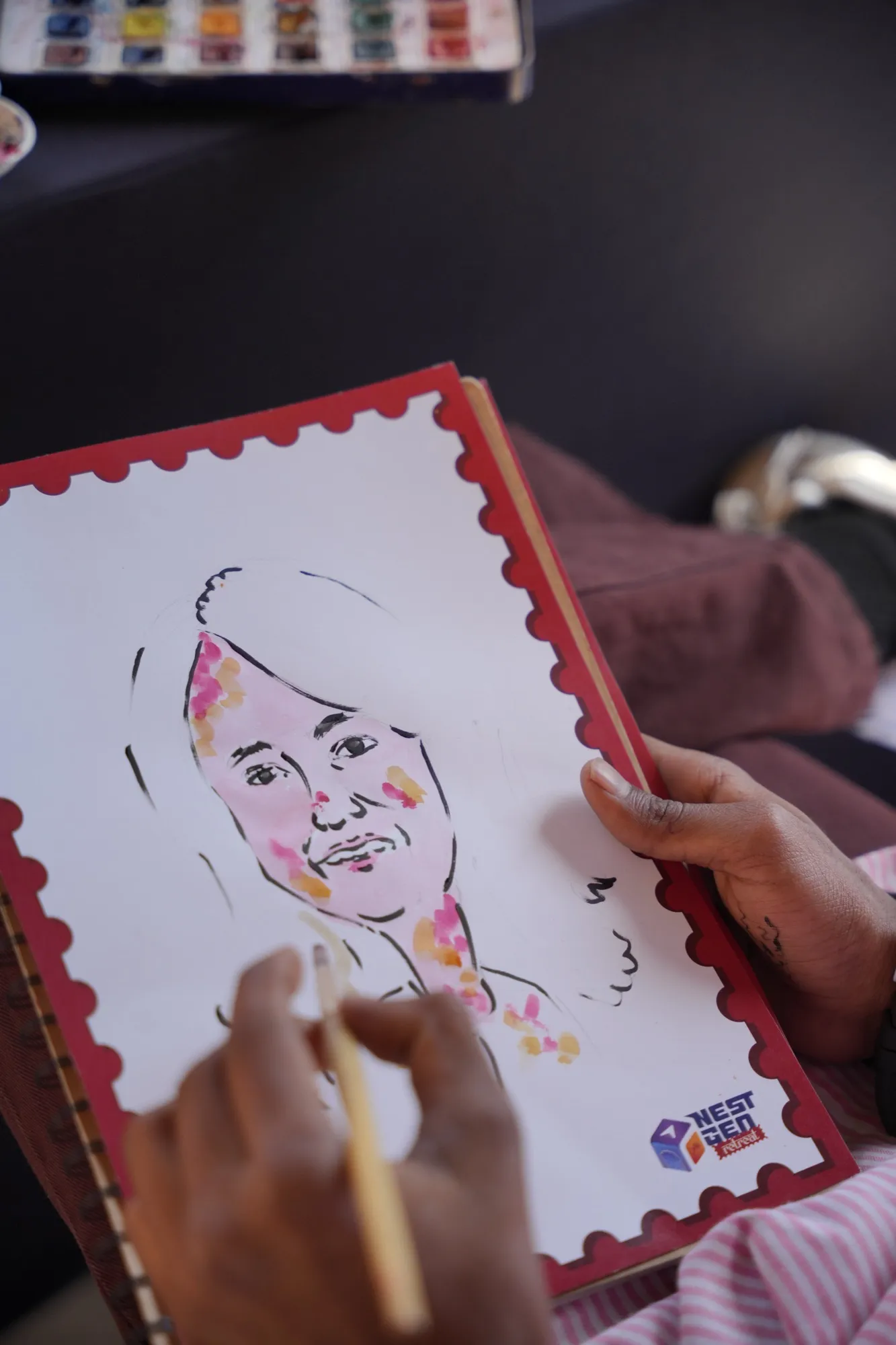 A caricature of a guest being painted inside a stamp-shaped frame