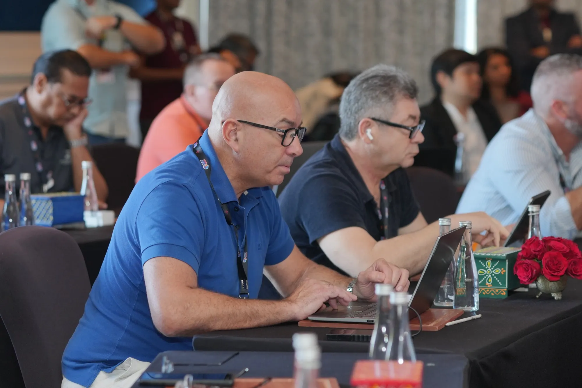 Pioneers listening and taking notes at the tables