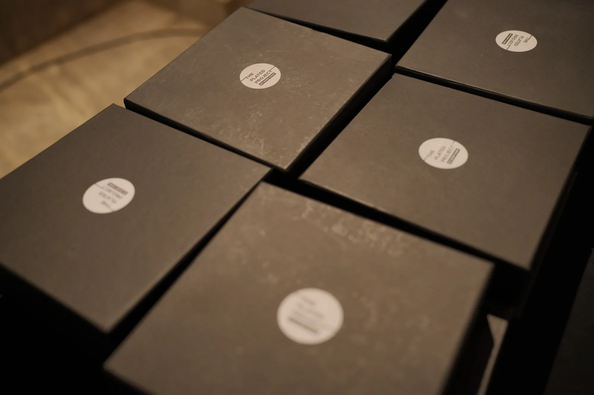 Black farewell gift boxes with round NestGen stickers