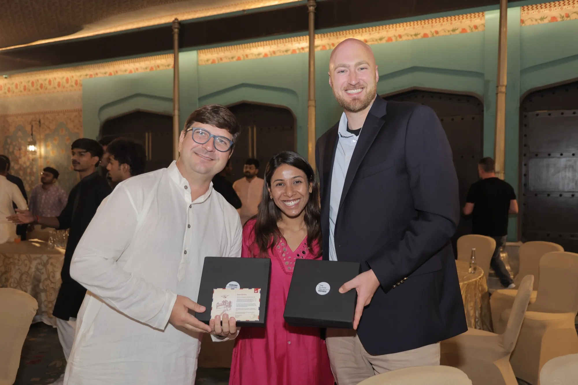 A guest receiving a gift bag from the hosts on stage