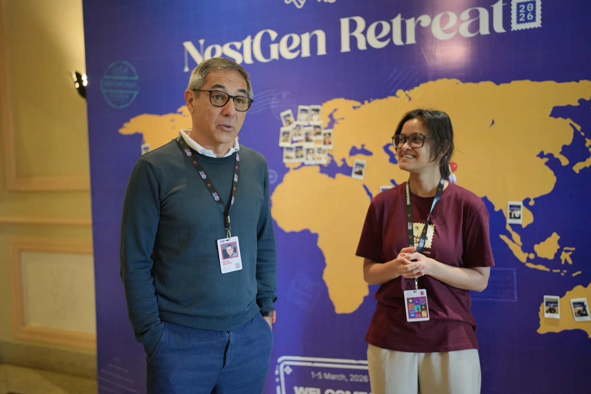 A pioneer and a host talking in front of the NestGen Retreat map wall