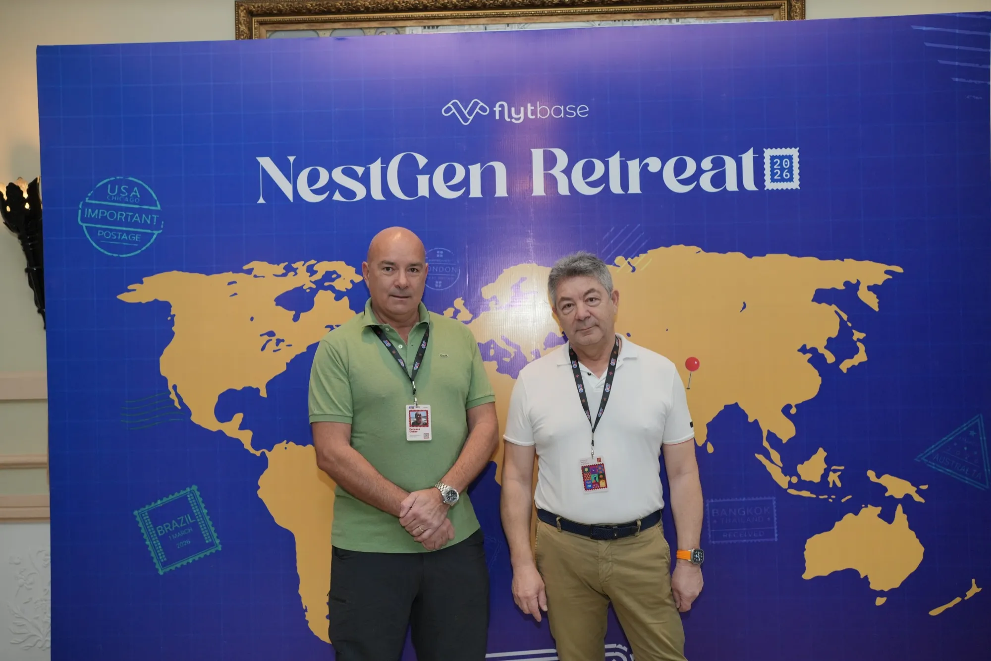 Two pioneers in front of the NestGen Retreat world map wall